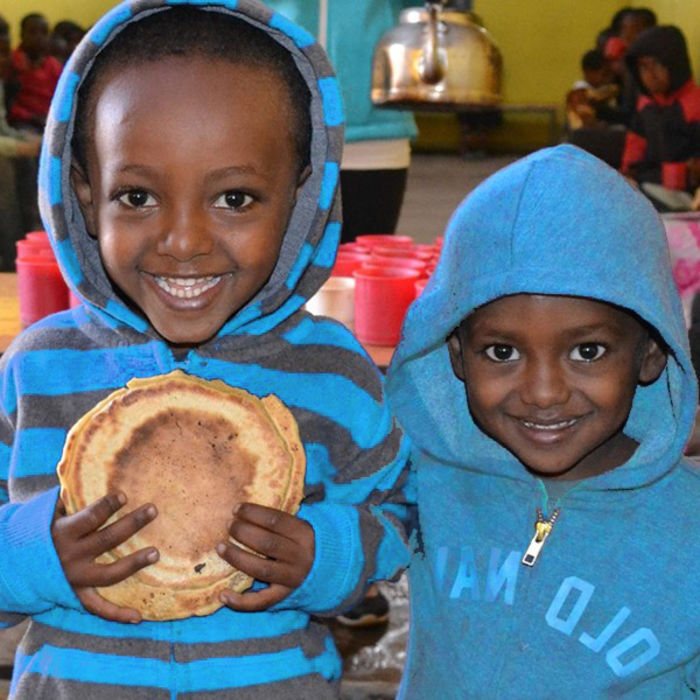 two happy boys holding nutritious food